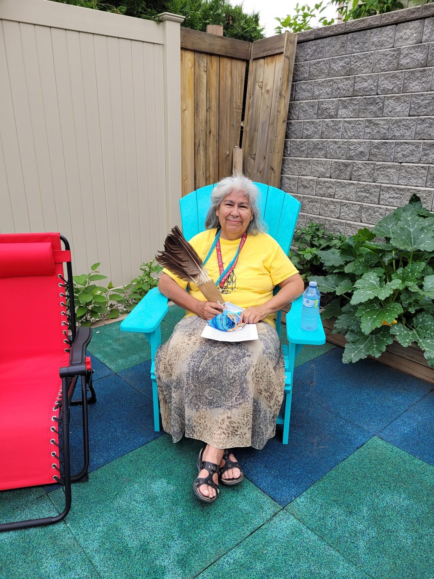 Louella Sitting with Bundle and Feathers