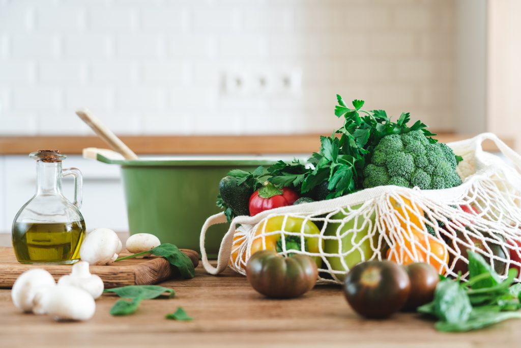 pot with fresh veggies and herbs in front of it