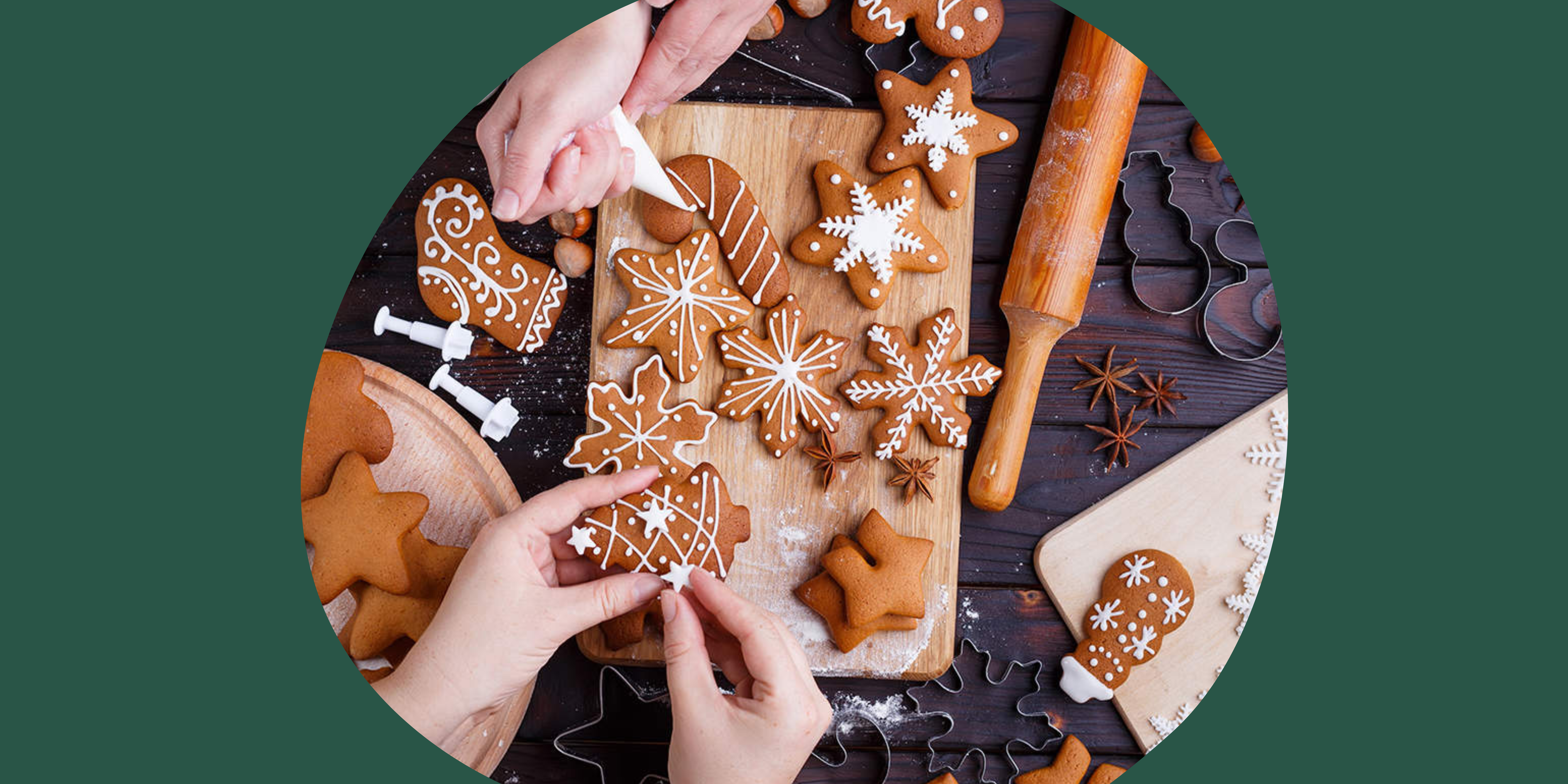 Christmas baked gingerbread in the shape of snow flakes, candy canes etc. being hand decorated