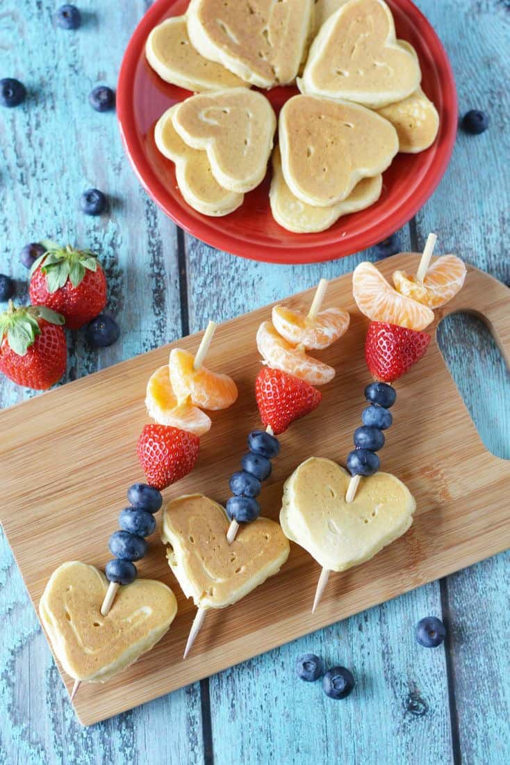 Pancakes shaped as hearts Berries on sticks