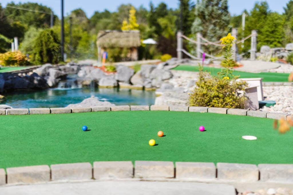 mini golf course with multi coloured golf balls on the course