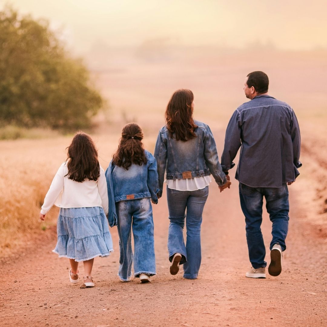 family walking on a dirt road
