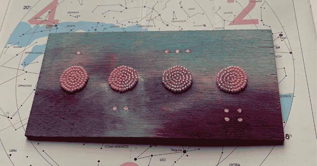 "Poster for the 'Moon Phases Beading Project' at Wabano. The poster features a painted wooden board in purple, blue, and pink tones displaying four circular beaded designs representing the primary lunar phases. The board sits on a star chart background. Text promotes a series of guided beading workshops where participants create lunar phases on a birch board using eco-conscious watercolours made from recycled food waste. Workshops begin October 30 and run every Friday from 3:00 p.m. to 4:30 p.m. in the Sky Room on the 3rd floor. Contact: Krystal Cox, Health Promotion Coordinator, 613-748-0657 ext. 231, kcox@wabano.com. Wabano logo appears at the bottom, along with the note: 'Funded by The Ministry of Health and Long Term Care.'